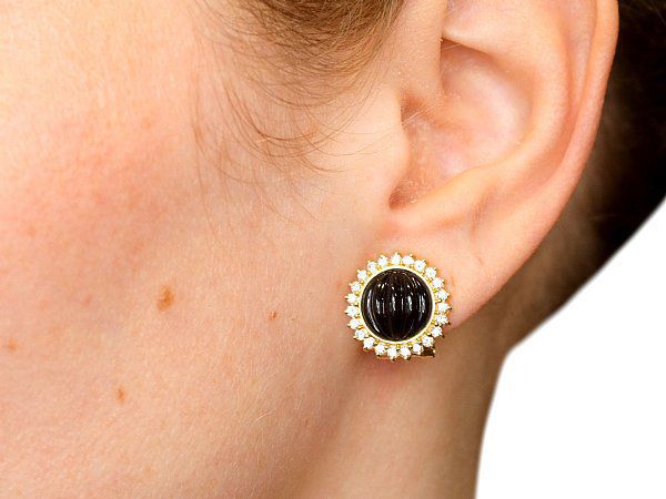 Wearing diamond earrings with a green dress