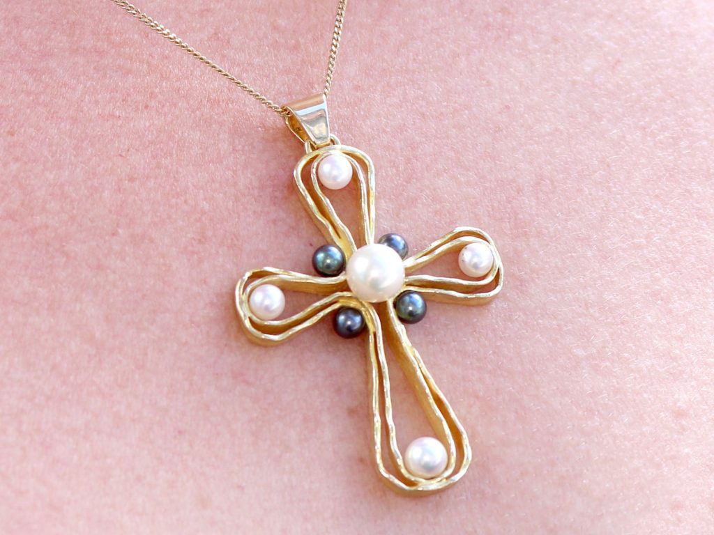 wearing gold and pearl 970s cross pendant