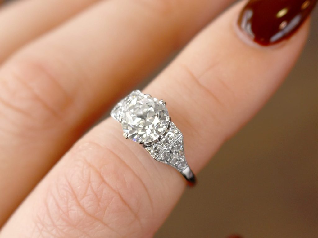 diamond solitaire ring on finger