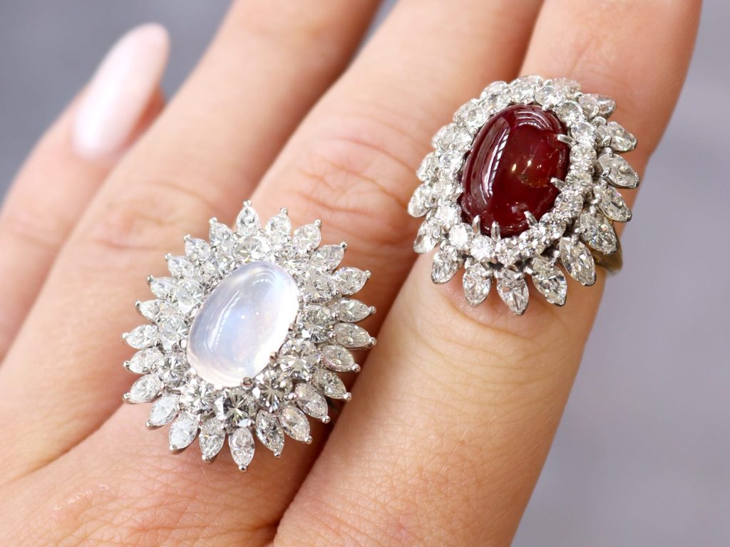 gemstone and diamond cluster rings on hand