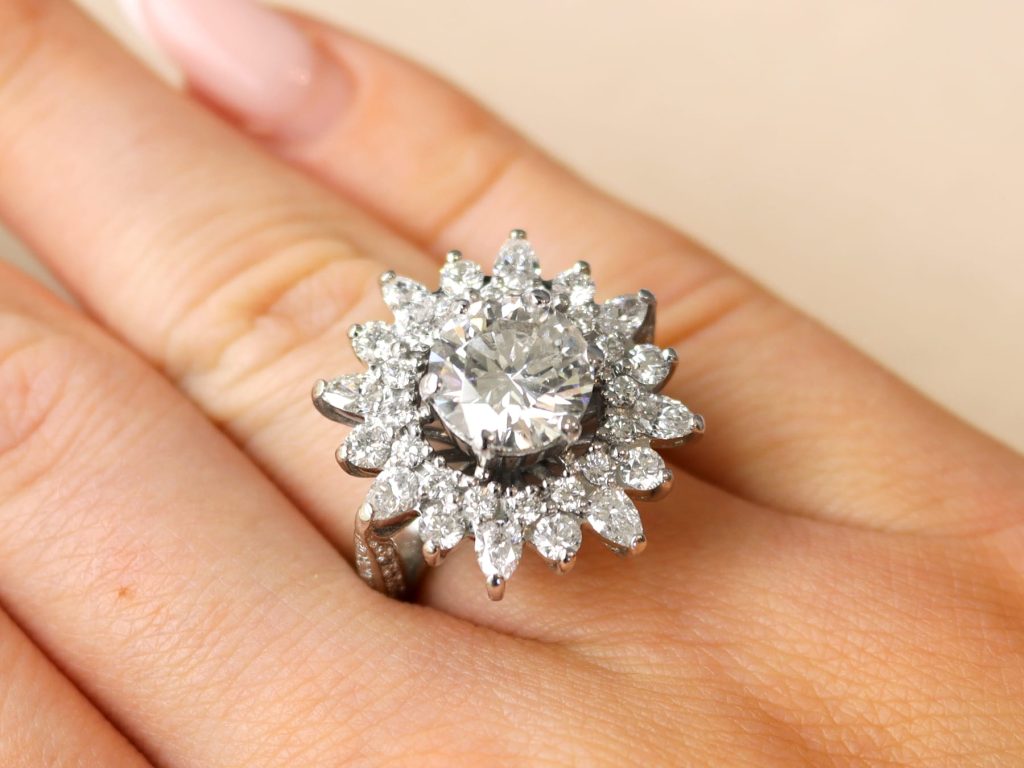 floral diamond cluster ring on finger