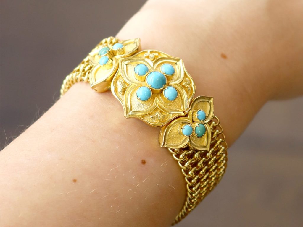 turquoise and yellow gold bracelet on wrist 