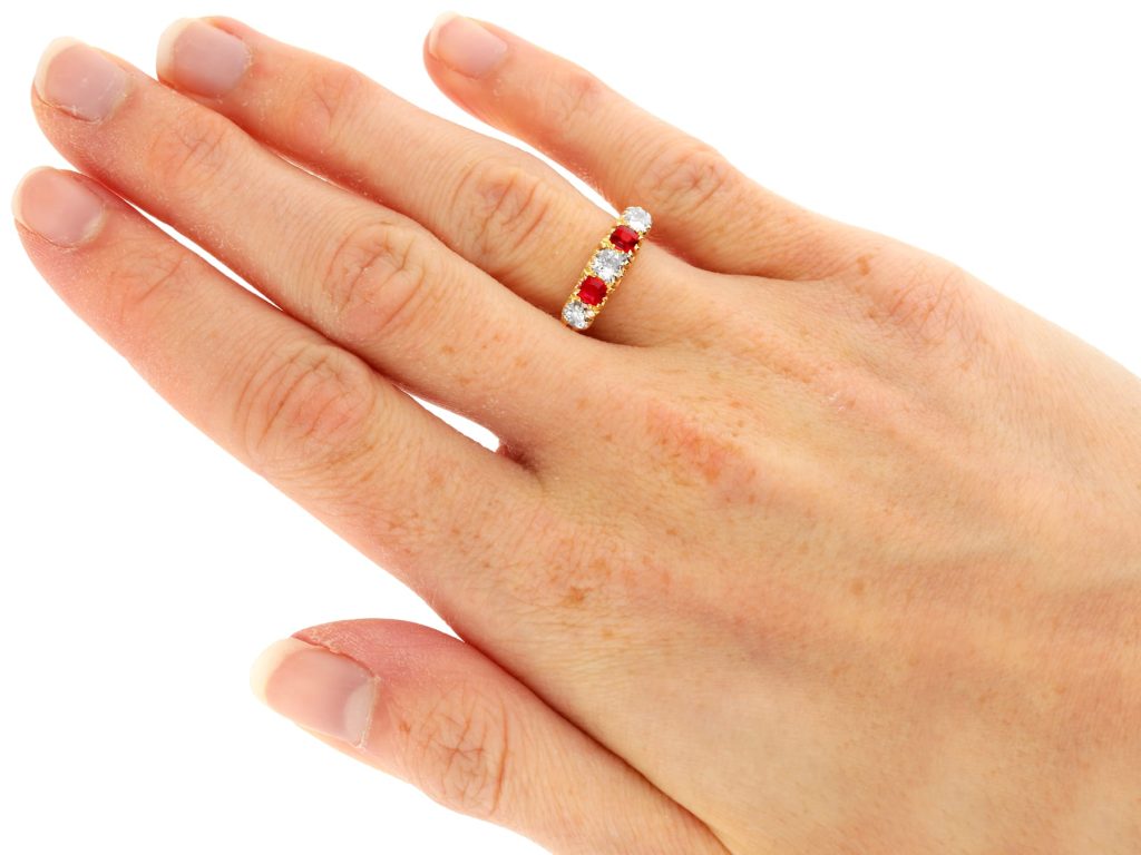 ruby and diamond five stone ring on finger 