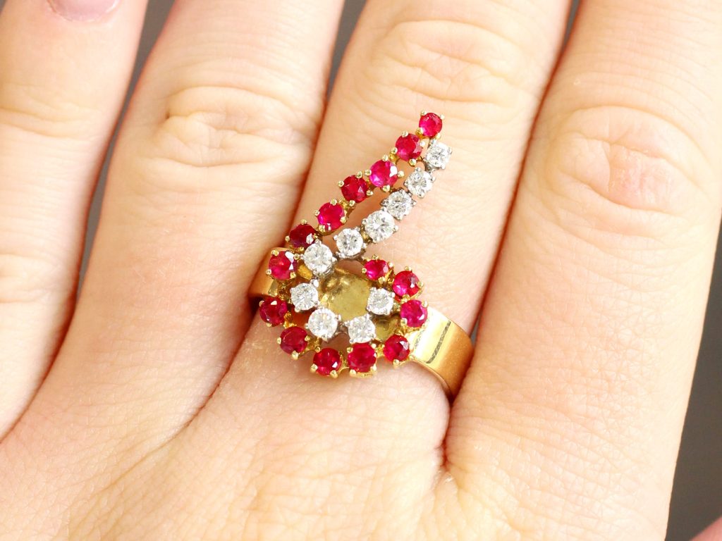 ruby and diamond yellow gold ring on finger 