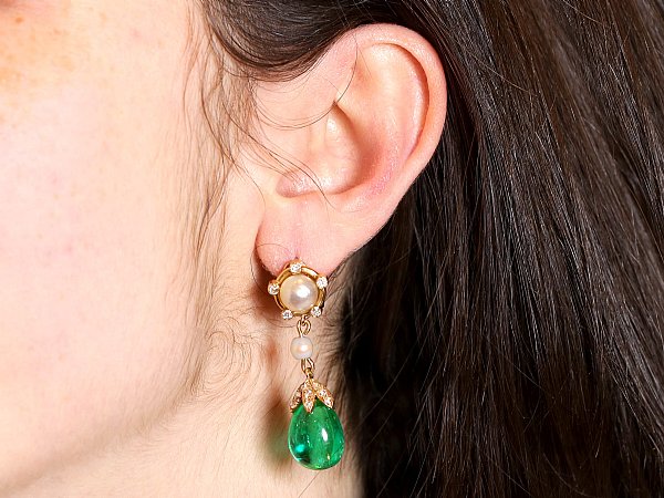 emerald and pearl drop earrings with brunette hair 
