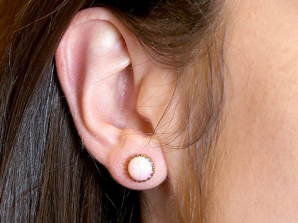 opal stud earrings in ear