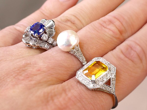 pearl ring on hand with gemstone rings